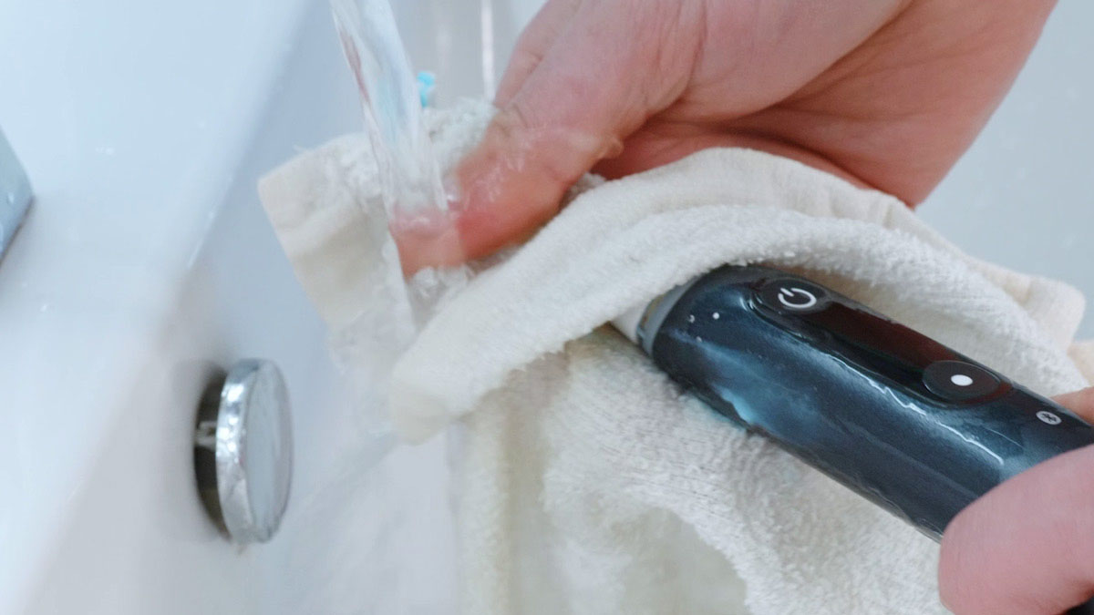 Toothbrush being cleaned under running water