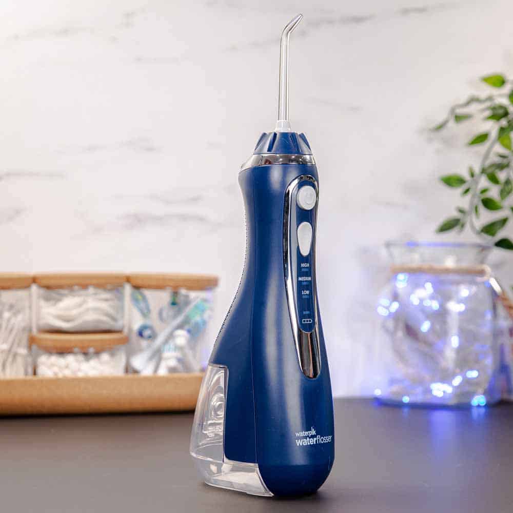 Blue Waterpik Cordless Advanced water flosser stood on countertop