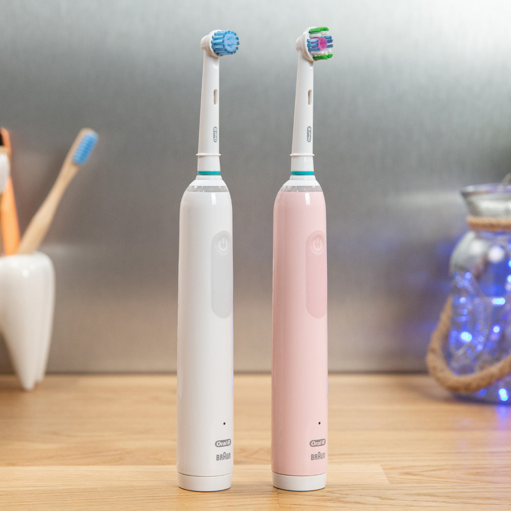 A white and a pink Oral-B Pro 3 stood next to each other