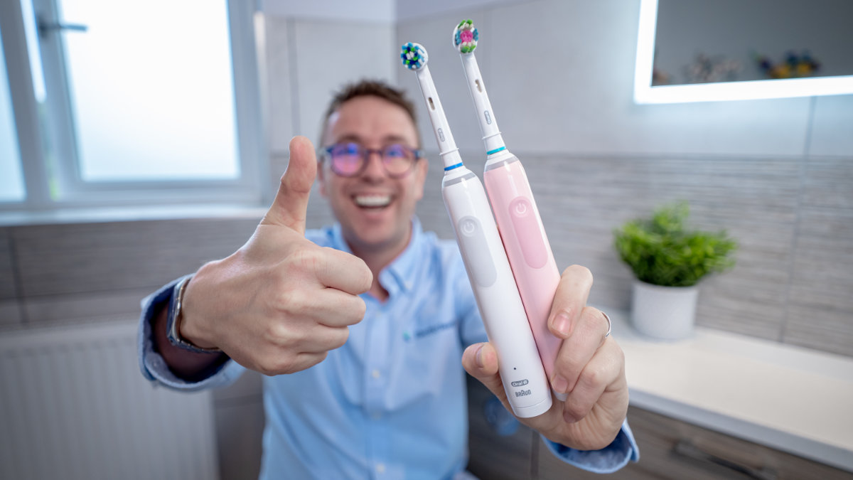 Jon Love holding two Oral-B Pro 3 brushes and giving a thumbs up
