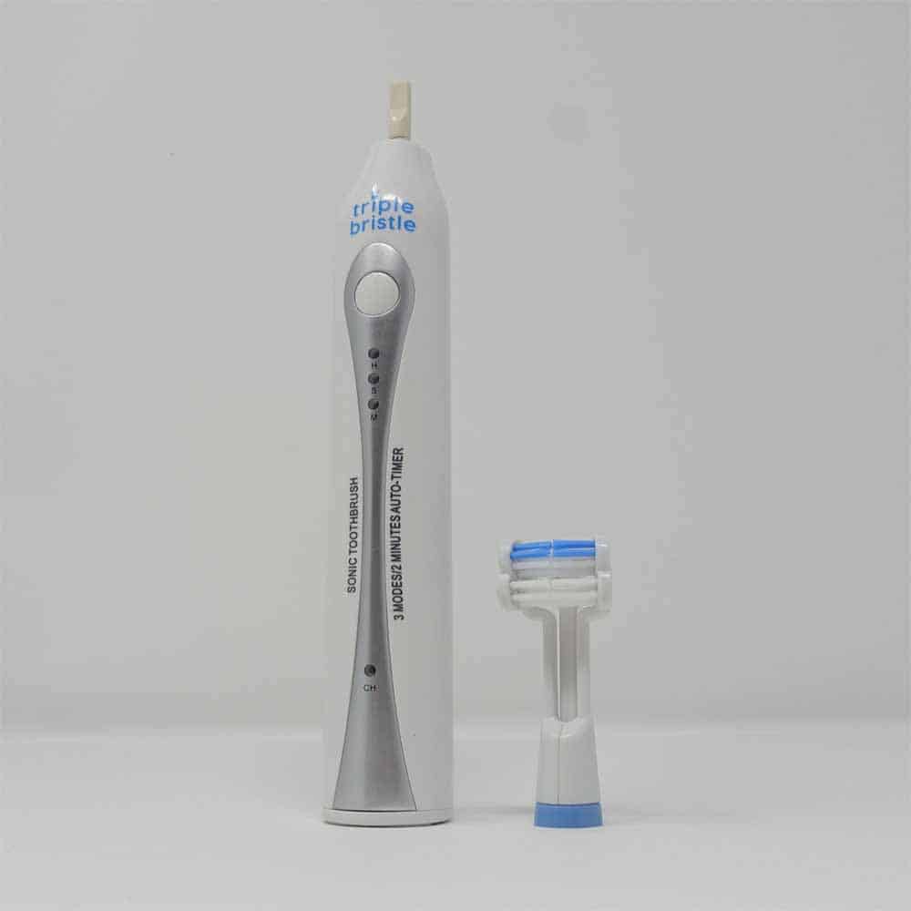Triple Bristle stood upright, with brush head detached & stood next to it