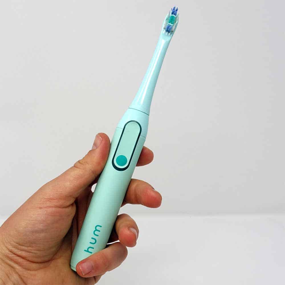 hum by Colgate in hand