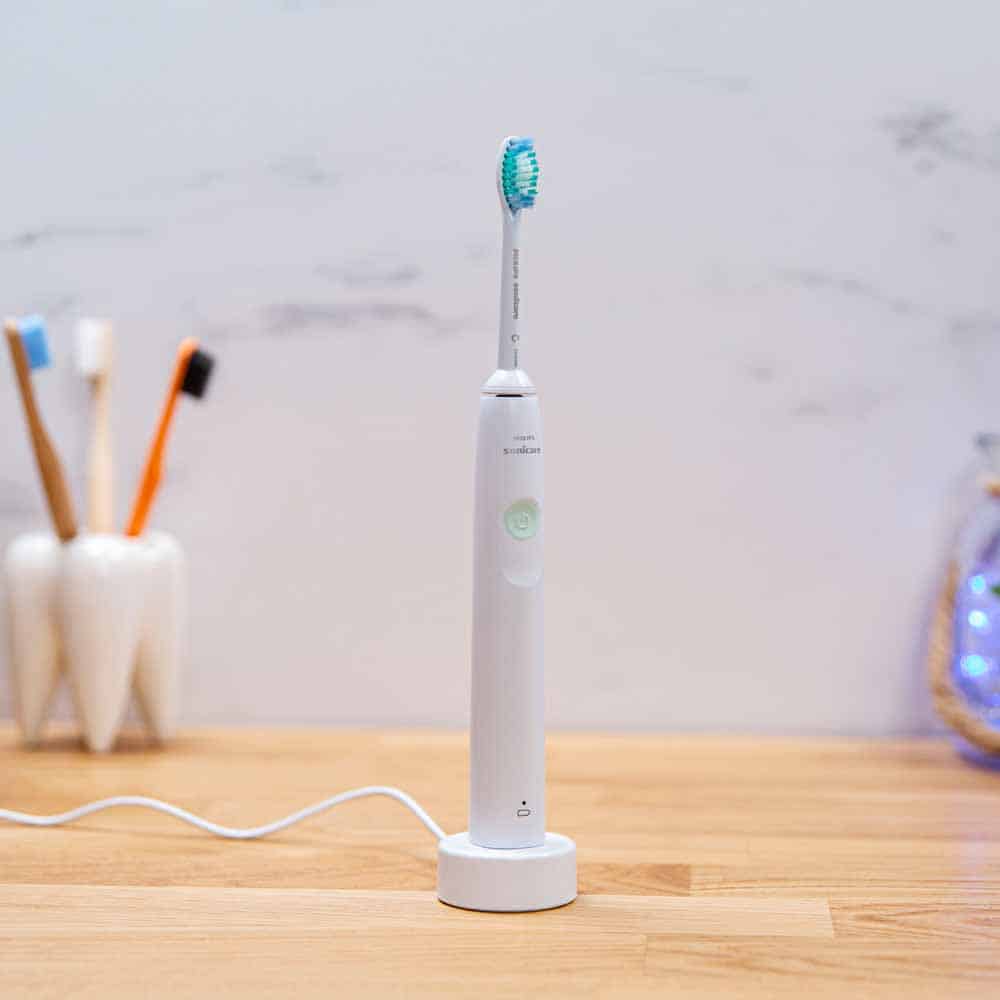 2100 Series electric toothbrush on USB charging stand